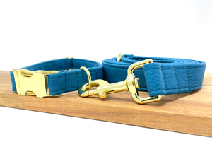 Solid Blue dog collar from The Oxford Dog with Gold hardware and matching leash. 
